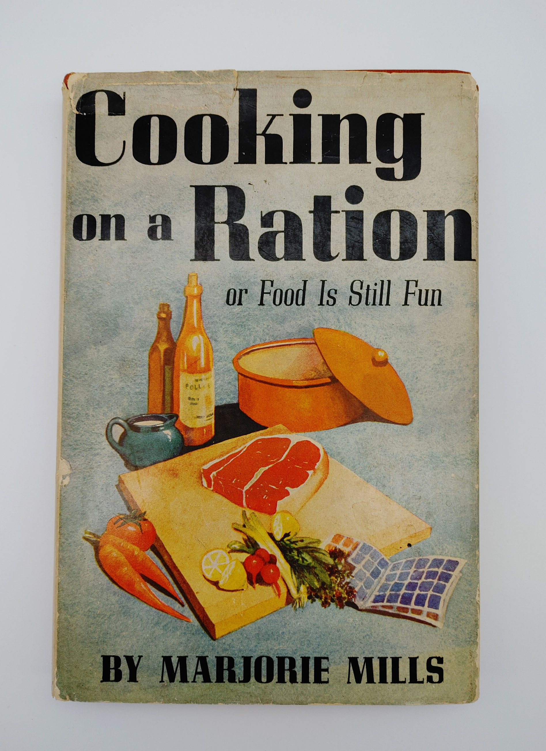 dust jacket from the first edition of Mills' Cooking on a Ration (1943)