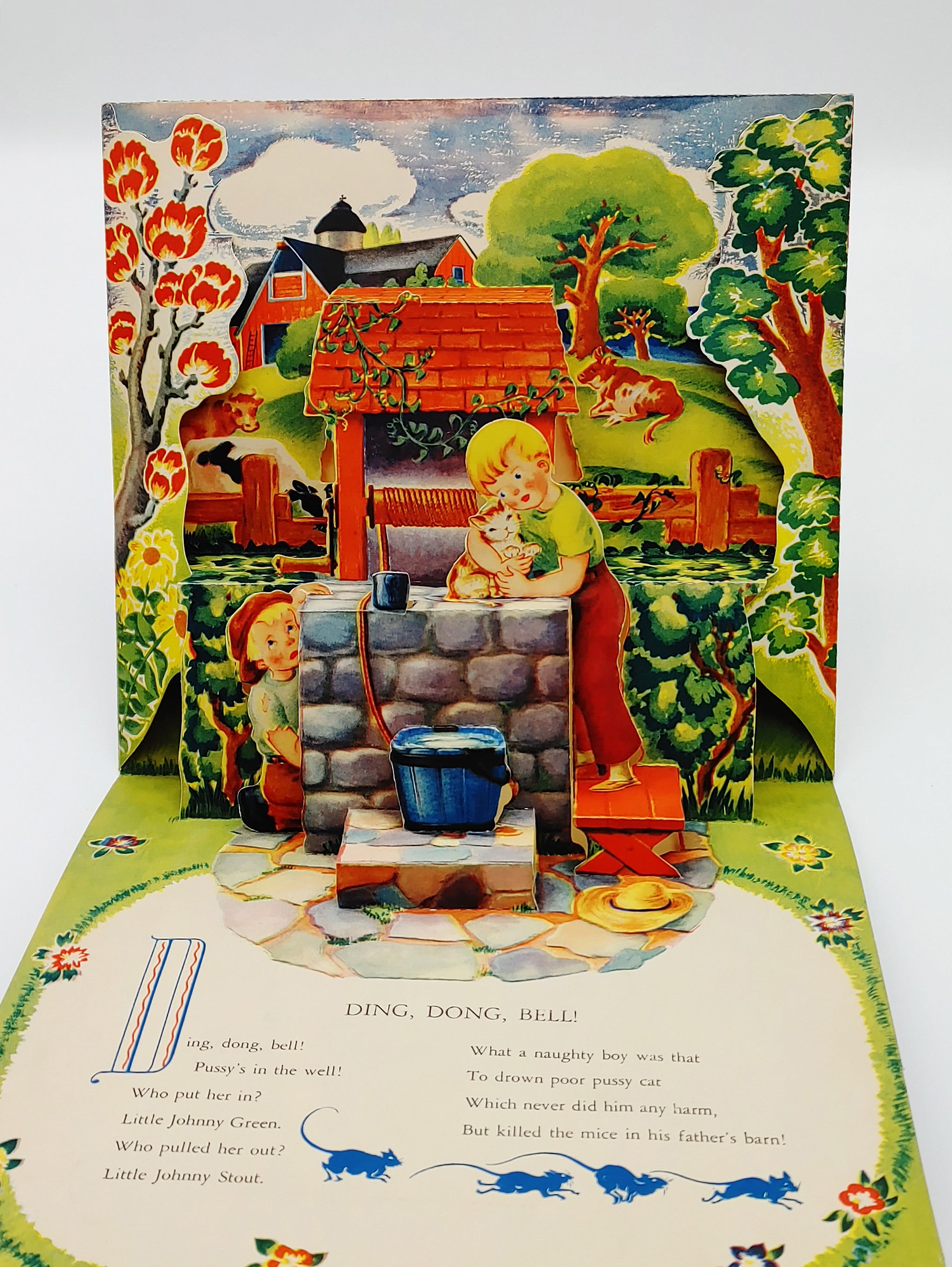Pop-up illustration of two boys at a well from the Geraldine Clyne's Ding, Dong, Bell!