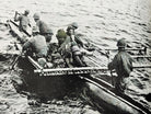 Image of people on a raft/boat from the first edition of Robinson's The Fight for New Guinea (1943)