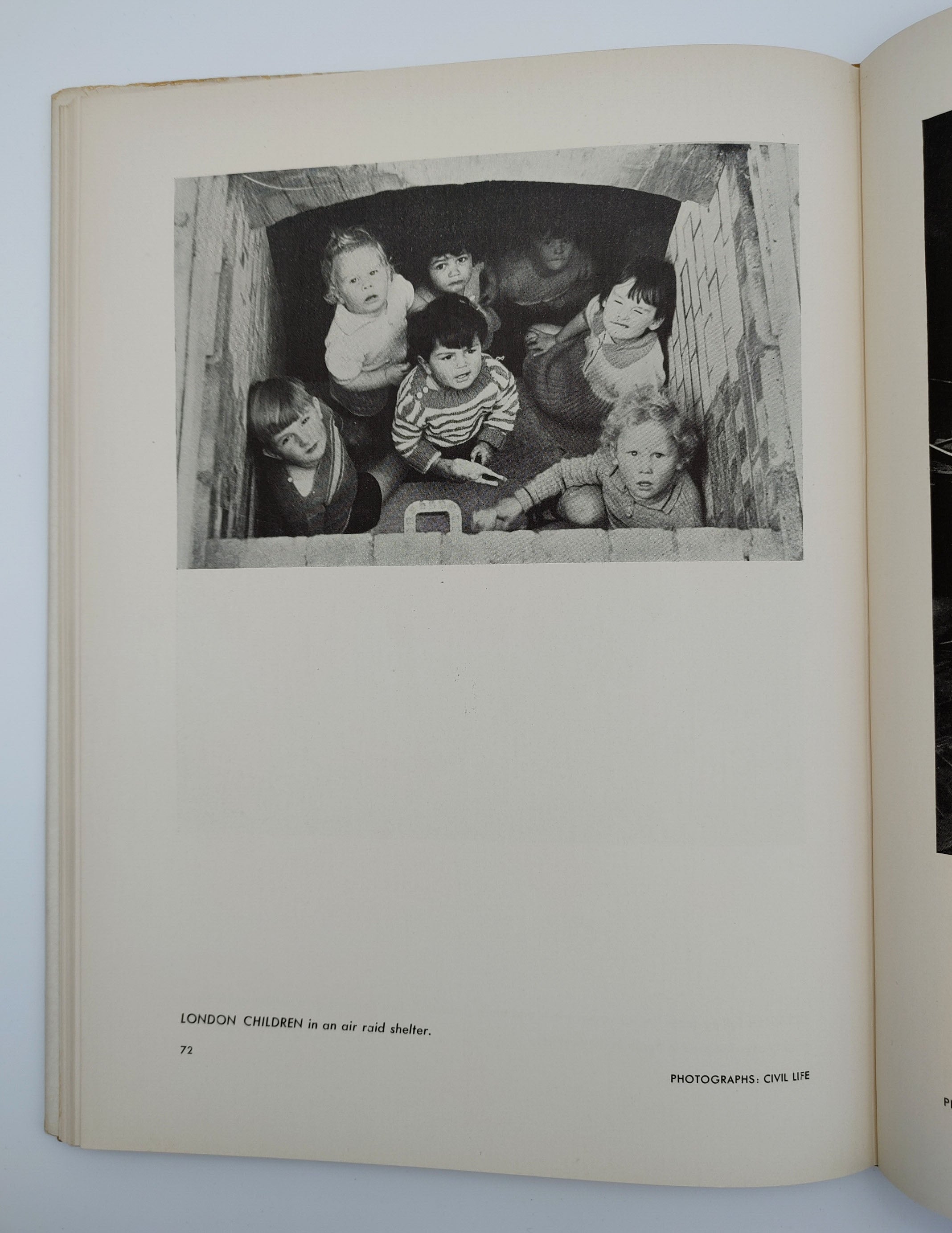 Picture of London children in an air raid shelter from the first edition of the Museum of Modern Art's Britain at War (1941)