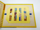 Slat moveable illustration of Goldilocks asleep in Baby Bear's bed from Emma McKean's Goldilocks and the Three Bears (1943)